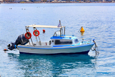 View of a small rescue boat with a powerful motor on the background of the beach coastline.