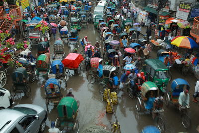 High angle view of people on street in rain