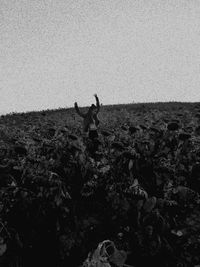 Man standing on field against clear sky