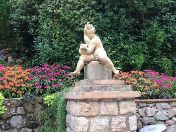 Statue against plants in park