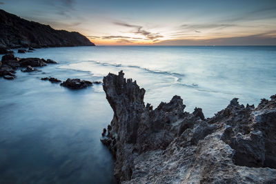 Scenic view of sea against sky at sunset