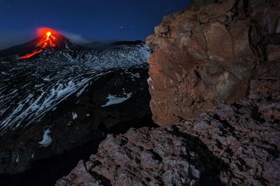 Rock formations against sky at night