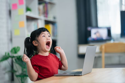 Young woman using laptop at home