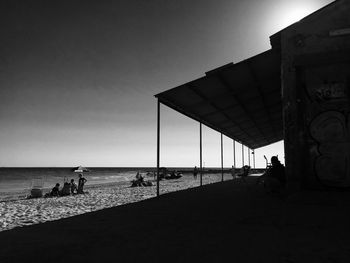 People on beach against sky