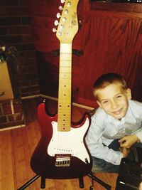 Portrait of boy playing guitar