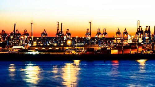 Boats in harbor at sunset