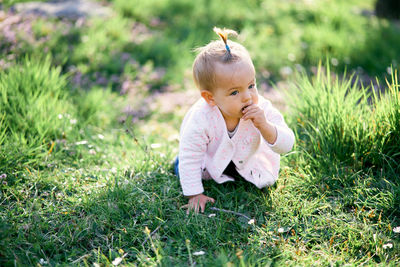 Cute girl sitting on grass