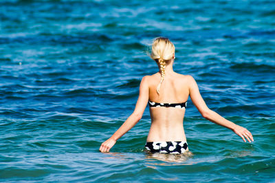 Rear view of woman in sea