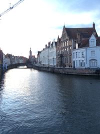 Bridge over river with buildings in background