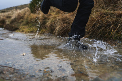 Low section of man splashing water