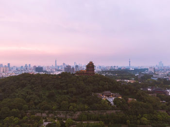 Buildings in city against sky during sunset