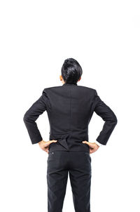 Rear view of man standing against white background