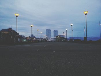 Empty road against cloudy sky