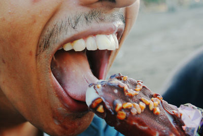 Close-up of man eating food