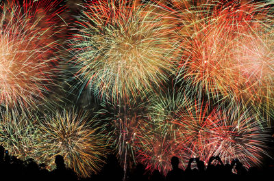 Low angle view of firework display at night