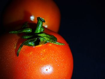 Close-up of tomato over black background