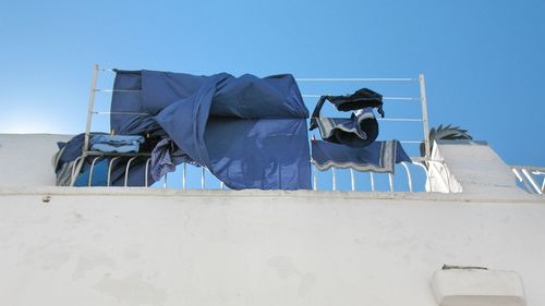 Low angle view of fabrics on building terrace