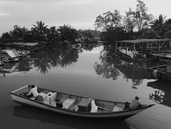 Boats moored in lake against sky