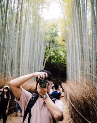 Portrait of young woman standing in forest
