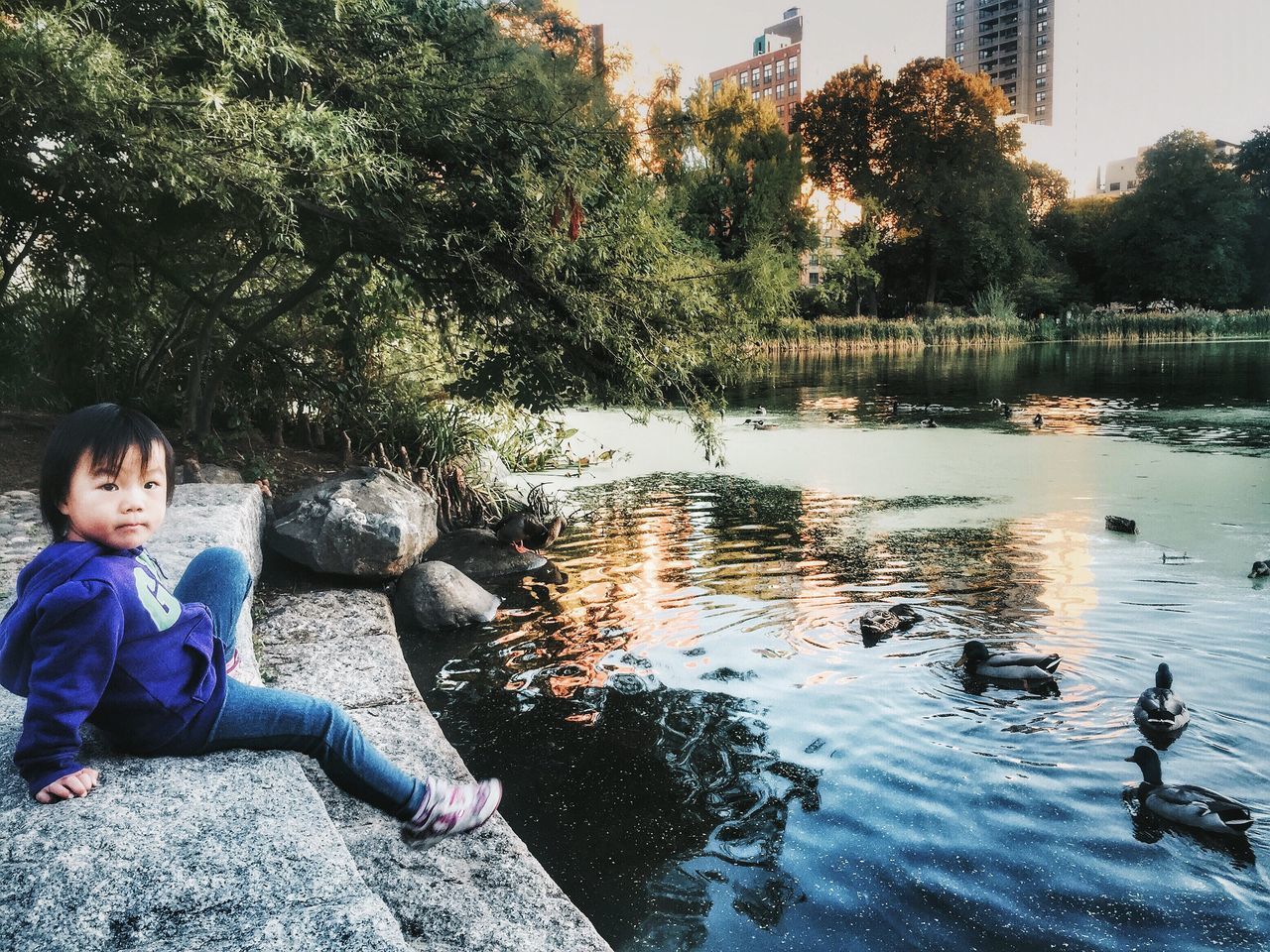 water, lifestyles, leisure activity, sitting, casual clothing, lake, tree, river, boys, full length, person, relaxation, togetherness, rock - object, childhood, men, standing