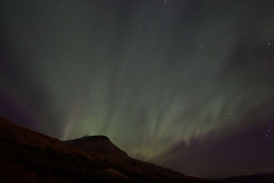 Low angle view of mountain against sky at night