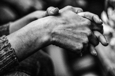 Close-up of woman with hands clasped