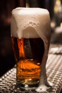 Close-up of beer glass on table