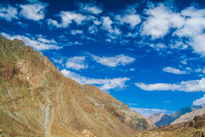 Scenic view of mountains against blue sky