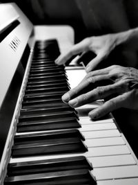 Cropped image of man playing piano