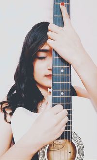 Low section of woman playing guitar