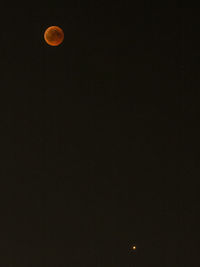 Low angle view of moon against sky at night