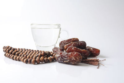 Close-up of drink on table against white background