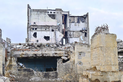 Damaged building against sky