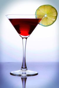 Close-up of wineglass against white background