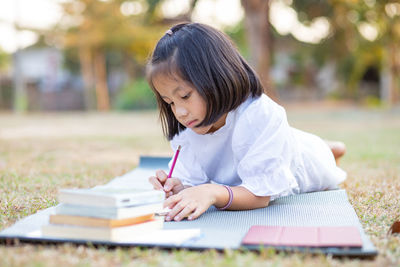 Girl sitting on book