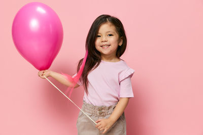 Portrait of young woman with balloons