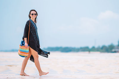 Young woman standing at beach