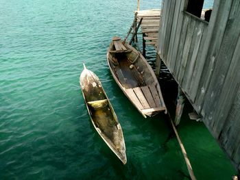 Wooden boats moored on island