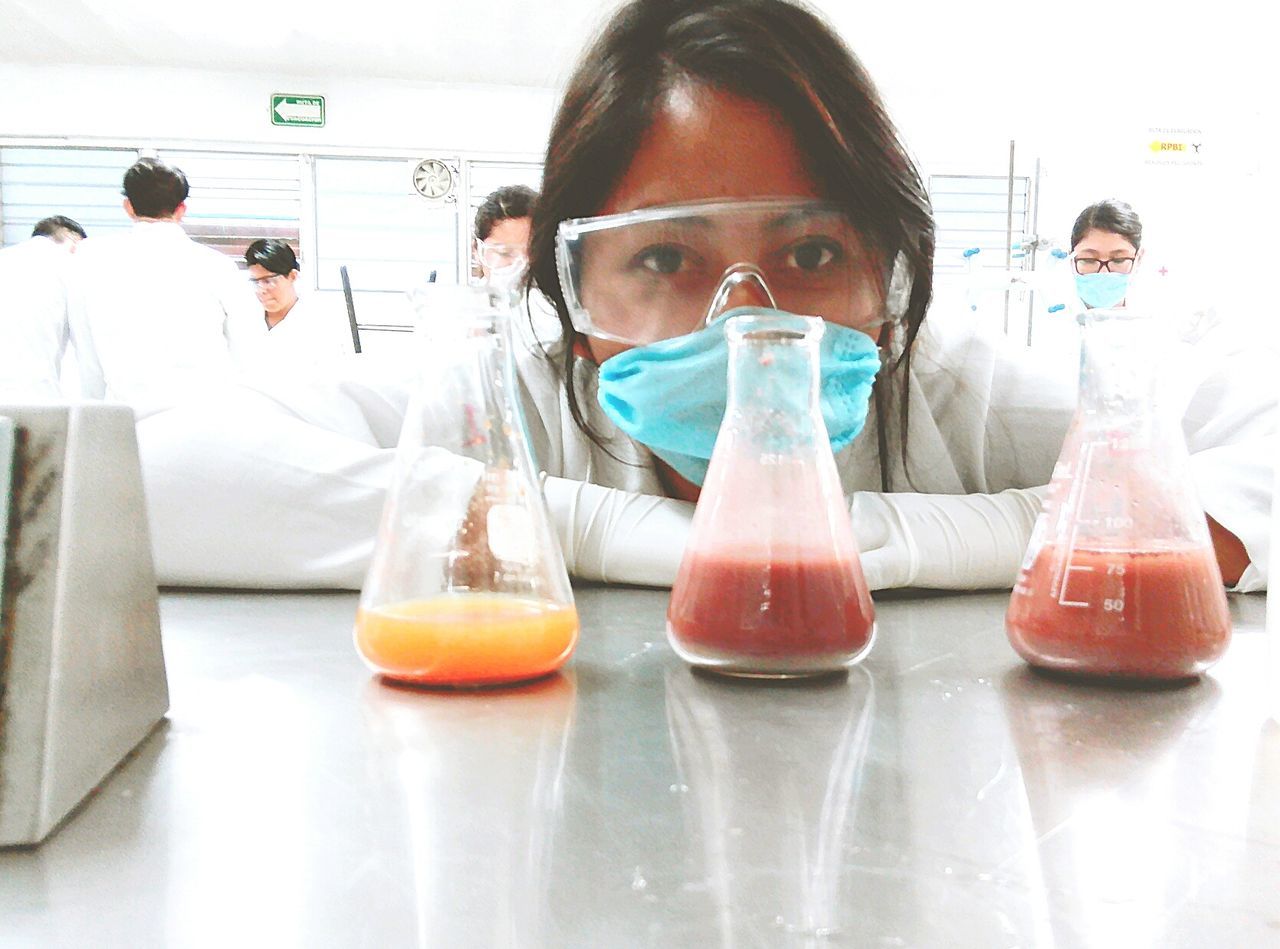 indoors, real people, science, laboratory, front view, scientific experiment, young women, research, young adult, protective workwear, eyeglasses, occupation, women, lab coat, men, one person, student, day, scientist, occupational safety and health, people