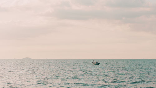 Boat on sea against sky during sunset