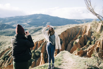 Panoramic view of people photographing mountains