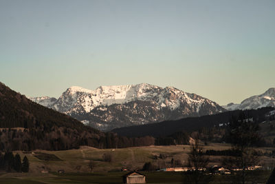 Scenic view of snowcapped mountains against clear sky