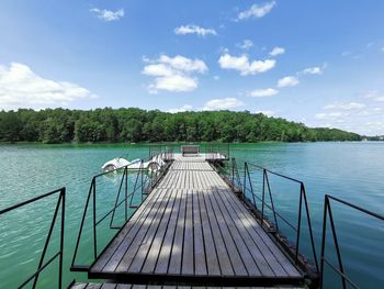 Pier over lake against sky