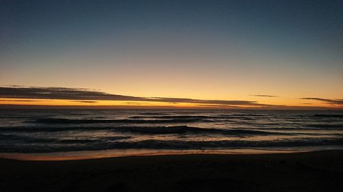 Scenic view of beach against sky during sunset
