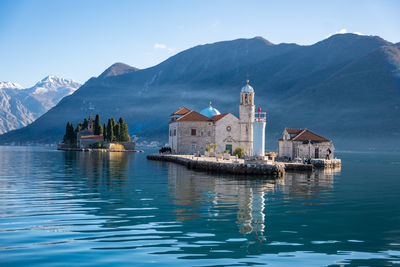 Scenic view of sea and mountains against sky