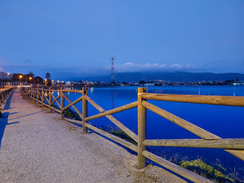 Pier over sea against blue sky