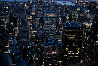 Aerial view of illuminated buildings in city at night