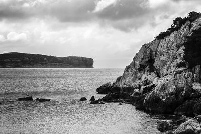 Scenic view of sea and mountains against sky