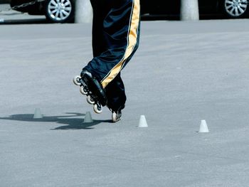 Low section of person skating on road