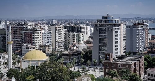 High angle view of buildings in city against sky